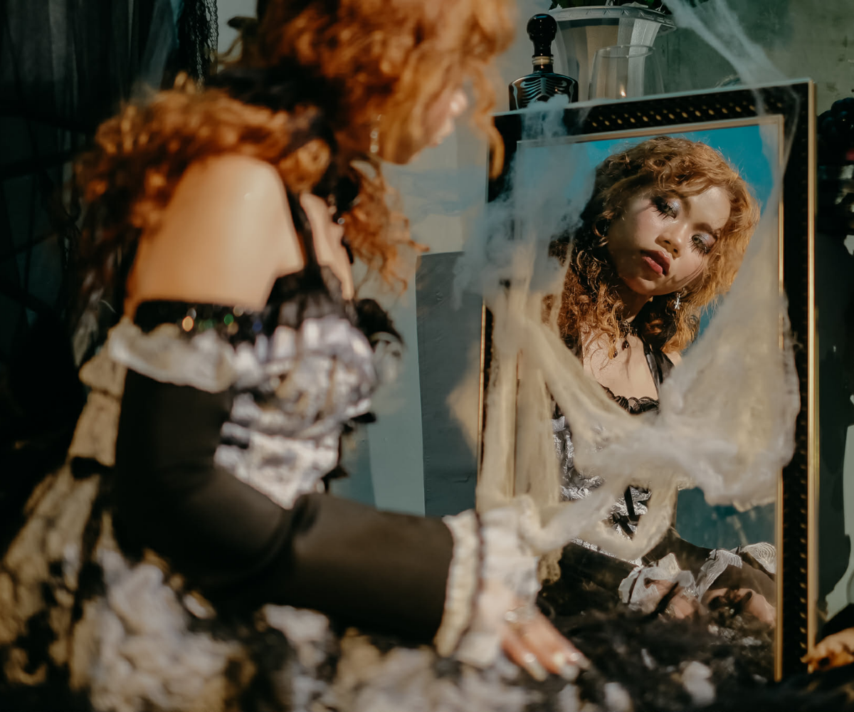Dhafney looking into a mirror